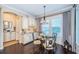 Charming breakfast nook with a glass table, elegant lighting, and custom cabinetry for added storage at 315 Manatee Ln, Tarpon Springs, FL 34689