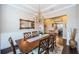 Elegant dining room with chandelier lighting, wood floors, and open view to kitchen at 315 Manatee Ln, Tarpon Springs, FL 34689