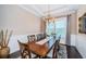 Formal dining room featuring a large table, elegant chandelier, and neutral decor at 315 Manatee Ln, Tarpon Springs, FL 34689