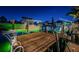 Nighttime shot of dock with boat lift, Adirondack chairs and ambient lighting, ideal for relaxing evenings by the water at 315 Manatee Ln, Tarpon Springs, FL 34689