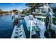Dock featuring boat lift, steps to the water, and lush landscaping, providing easy access and visual appeal at 315 Manatee Ln, Tarpon Springs, FL 34689