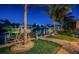 Waterfront property boasts a dock with boat lift, lush landscaping, and charming outdoor seating for enjoying tranquil evenings at 315 Manatee Ln, Tarpon Springs, FL 34689
