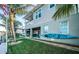 Two-story home with a well-manicured lawn, and waterfront backyard patio at 315 Manatee Ln, Tarpon Springs, FL 34689