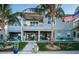 Two-story home with a patio, balcony, outdoor kitchen, a lush lawn, and well-maintained landscaping at 315 Manatee Ln, Tarpon Springs, FL 34689