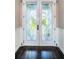 Elegant double front doors with decorative glass, dark wood floors, and classic trim at 315 Manatee Ln, Tarpon Springs, FL 34689