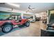 Well-organized garage offers parking and storage with a workspace in a room with light aqua walls at 315 Manatee Ln, Tarpon Springs, FL 34689