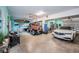 Spacious garage with epoxy flooring, car lift, and ample space for vehicles and storage at 315 Manatee Ln, Tarpon Springs, FL 34689