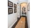 Hallway with a rug and dark wood floors leading to a bedroom at 315 Manatee Ln, Tarpon Springs, FL 34689