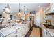 Open kitchen showcases a large island with a sink and seating, complemented by custom cabinetry and granite counters at 315 Manatee Ln, Tarpon Springs, FL 34689