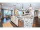 Well-lit kitchen with large island, granite countertops, stainless steel appliances and view to the living room at 315 Manatee Ln, Tarpon Springs, FL 34689