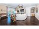 Inviting living room featuring dark wood floors, fireplace, and a large curved sofa at 315 Manatee Ln, Tarpon Springs, FL 34689