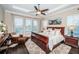 Serene main bedroom boasts tray ceilings, abundant natural light from large windows, and a cozy sitting area at 315 Manatee Ln, Tarpon Springs, FL 34689