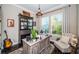 Cozy home office featuring a rustic desk, stylish decor, and bright natural light from the windows at 315 Manatee Ln, Tarpon Springs, FL 34689