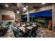 Covered patio with dining area, seating, grill, decor, and beautiful evening views, perfect for entertaining at 315 Manatee Ln, Tarpon Springs, FL 34689