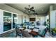 Covered patio with dining, seating, grill, fans, and décor creating a relaxing and functional outdoor space at 315 Manatee Ln, Tarpon Springs, FL 34689