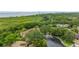 Beautiful aerial view of homes, green landscaping, and scenic waterfront in the distance at 318 Parkside Ln, Safety Harbor, FL 34695