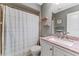 Bathroom featuring shower/tub, modern sink with pink granite countertops, and neutral gray paint color at 318 Parkside Ln, Safety Harbor, FL 34695