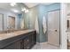 Well-lit bathroom featuring dual sinks, granite counters, modern fixtures, and ample storage at 318 Parkside Ln, Safety Harbor, FL 34695