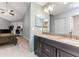 Bathroom featuring double vanity, granite countertops, tile flooring, and a view into the main bedroom and office at 318 Parkside Ln, Safety Harbor, FL 34695