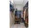 Walk-in closet with built-in shelves and hanging racks provides ample storage space for clothing and accessories at 318 Parkside Ln, Safety Harbor, FL 34695
