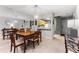 Inviting dining room with modern light fixture, wood table, and seating for six, next to the kitchen at 318 Parkside Ln, Safety Harbor, FL 34695