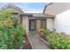 Inviting front entrance featuring a walkway lined with lush landscaping and colorful flowerbeds at 318 Parkside Ln, Safety Harbor, FL 34695
