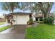 Charming single Gathering home showcasing a well manicured lawn and attached one car garage at 318 Parkside Ln, Safety Harbor, FL 34695