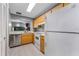 Efficient kitchen with stainless dishwasher, wood cabinets, and white appliances at 318 Parkside Ln, Safety Harbor, FL 34695
