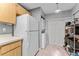 Convenient in-unit laundry area with stackable washer and dryer, adjacent to pantry shelves at 318 Parkside Ln, Safety Harbor, FL 34695