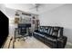 The living room has tile floors, a ceiling fan, a wall-mounted flat-screen tv and a black leather couch at 318 Parkside Ln, Safety Harbor, FL 34695