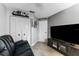 The living room has tile floors, a ceiling fan, a wall-mounted flat-screen tv and a black leather couch at 318 Parkside Ln, Safety Harbor, FL 34695