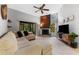 Comfortable living room featuring a stylish fireplace, vaulted ceilings, and sliding glass doors to a patio at 318 Parkside Ln, Safety Harbor, FL 34695