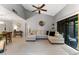 Spacious living room with a large sectional couch, vaulted ceilings, and access to the outdoor space at 318 Parkside Ln, Safety Harbor, FL 34695