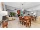 Bright and airy dining and living space with neutral walls, tile flooring, and a modern light fixture at 318 Parkside Ln, Safety Harbor, FL 34695