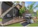 Relaxing screened-in patio with wood floors, outdoor grill, lush greenery, and comfortable seating at 318 Parkside Ln, Safety Harbor, FL 34695
