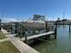 Boat on a lift at private dock, ready to be placed in the water for some nautical fun in the sun at 329 Medallion Blvd # C, Madeira Beach, FL 33708