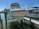 Boat on a lift at private dock, ready to be placed in the water for some nautical fun in the sun at 329 Medallion Blvd # C, Madeira Beach, FL 33708