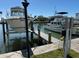 View of two boats at the private dock, both lifted out of the water after a long day of boating at 329 Medallion Blvd # C, Madeira Beach, FL 33708