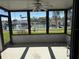 Screened porch offering views of the marina, seamlessly blending indoor-outdoor living at 329 Medallion Blvd # C, Madeira Beach, FL 33708