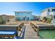 Home boasts a spacious backyard, including a wooden dock, patio, and waterfront access at 330 176Th Avenue Cir, Redington Shores, FL 33708