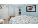 Bedroom showcases coastal themed bedspread, blue walls, and a playful elephant picture hanging on the wall at 330 176Th Avenue Cir, Redington Shores, FL 33708