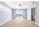 Bedroom featuring tile floors, ceiling fan, slider to water, plantation shutters and walk-in closet at 330 176Th Avenue Cir, Redington Shores, FL 33708