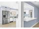 Modern kitchen featuring stainless steel appliances, white cabinetry, and a breakfast bar at 330 176Th Avenue Cir, Redington Shores, FL 33708