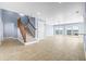 Open living area with tile floors, stairs, neutral color palette, and sliding doors with waterfront views at 330 176Th Avenue Cir, Redington Shores, FL 33708