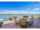 Outdoor patio seating includes view of the water and dock with plenty of seating at 330 176Th Avenue Cir, Redington Shores, FL 33708