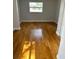 Bedroom featuring wood floors, grey paint, window view to outside and white trim at 3718 19Th S Ave, St Petersburg, FL 33711