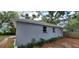 Gray house featuring two windows with simple trim and native landscaping at 3718 19Th S Ave, St Petersburg, FL 33711