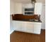 An efficient kitchen features white cabinets, laminate countertops, and a stainless steel sink, blending functionality with streamlined design at 3718 19Th S Ave, St Petersburg, FL 33711