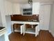 A modest kitchen reveals white cabinets, laminate countertops, and a stainless steel sink for streamlined cooking and cleanup at 3718 19Th S Ave, St Petersburg, FL 33711