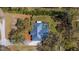 Stunning aerial view of a charming home with a pool, surrounded by lush trees and landscaping at 37350 Neighbors Path, Zephyrhills, FL 33542